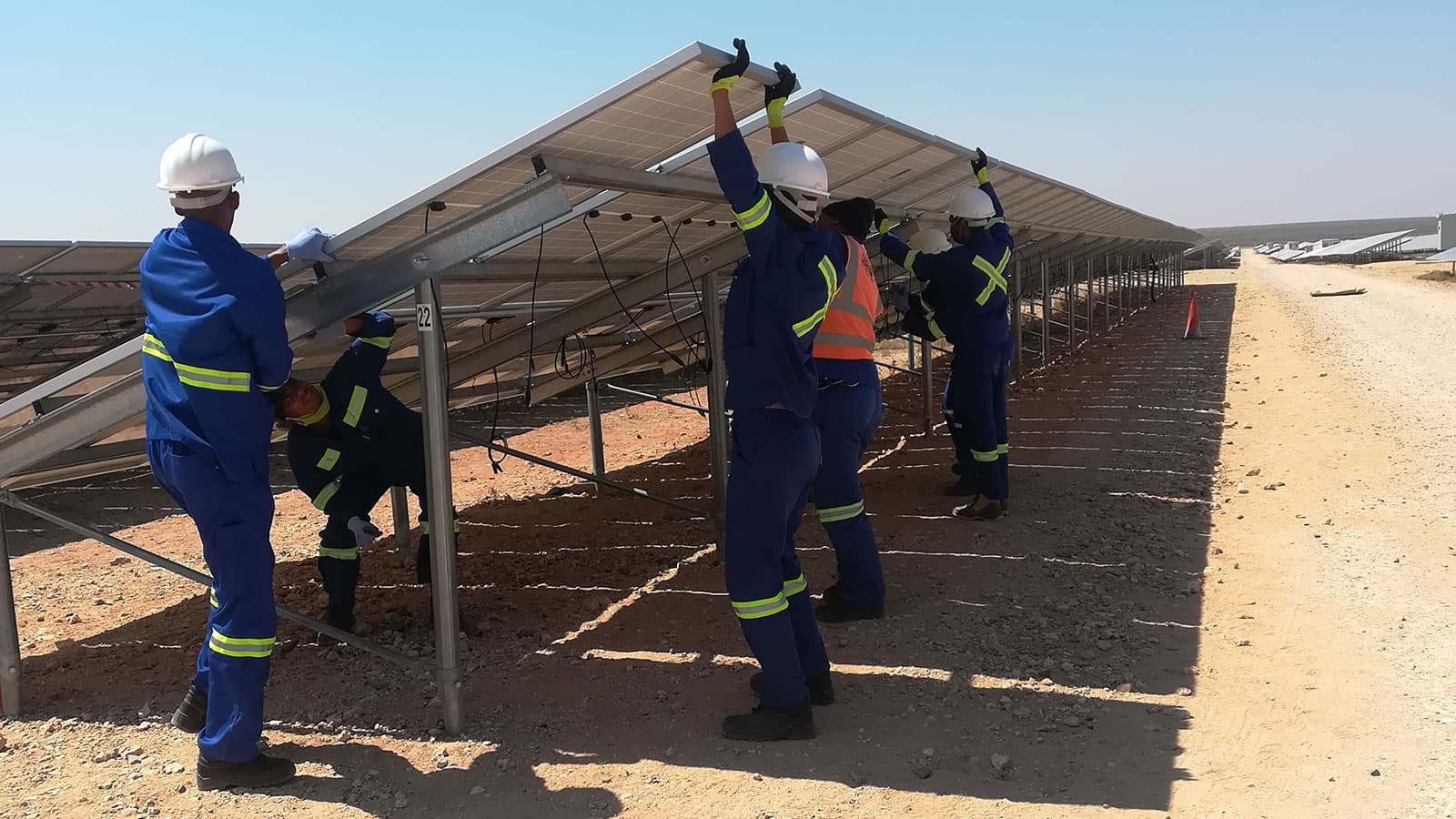 Quebar crew working on photovoltaic modules at a Northern Cape solar plant